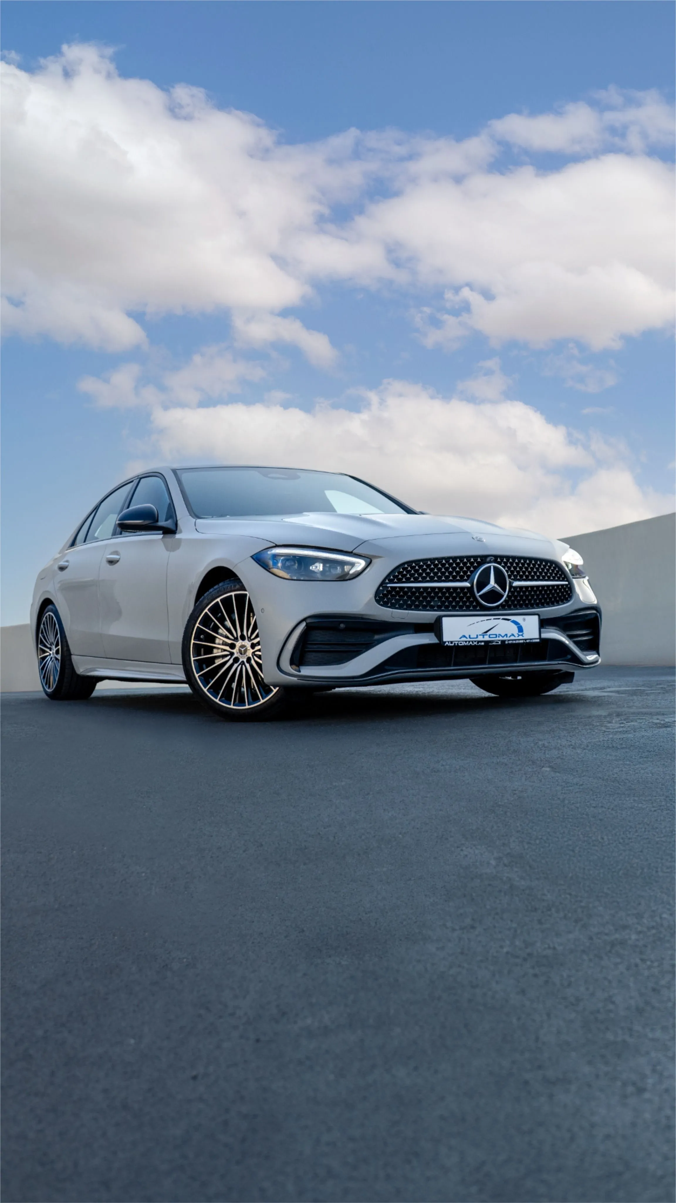 White Mercedes Coupe Parked Under Blue Sky on Blacktop