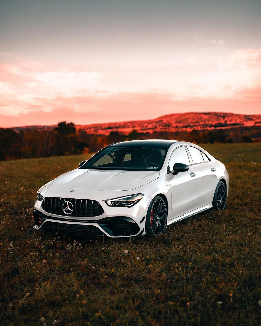 White Mercedes Coupe Posed Against Scenic Sunset Field