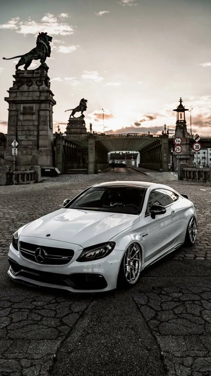 White Mercedes Coupe Posed by Historic City Landmark