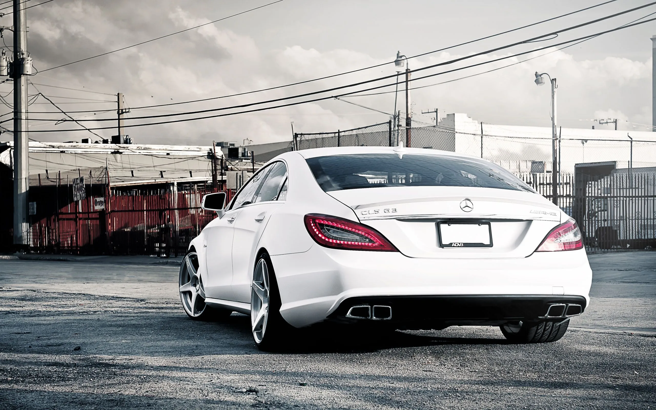 White Mercedes Driving Through Urban Cityscape Wallpaper