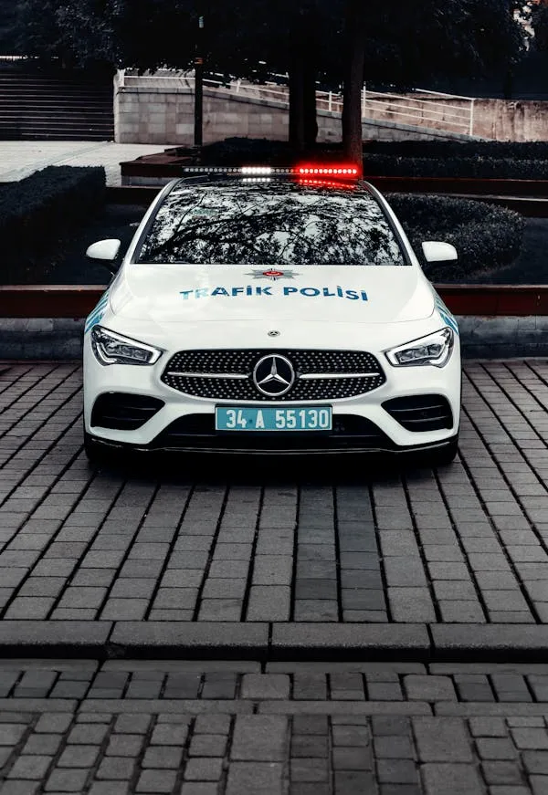 White Mercedes Police Car Parked in Urban Street Wallpaper