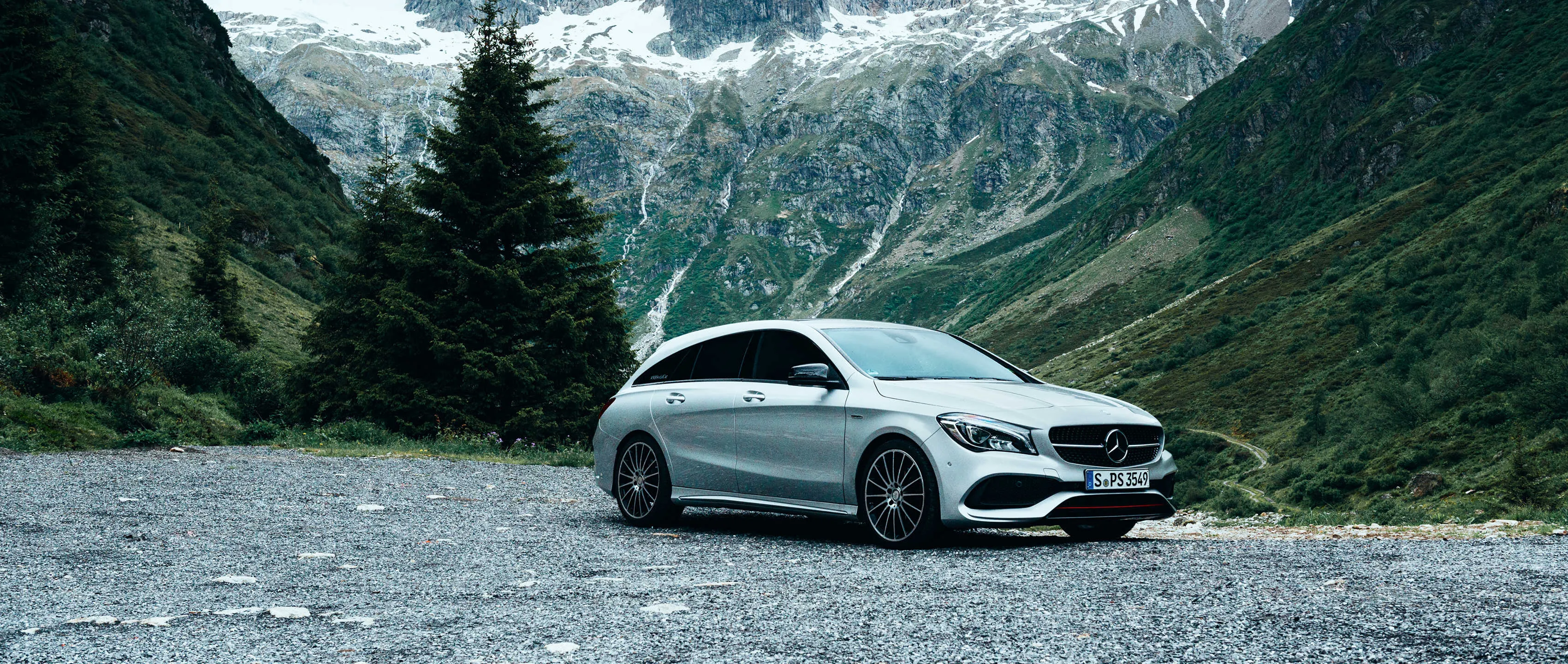 White Mercedes Sedan Driving in High Mountain Region