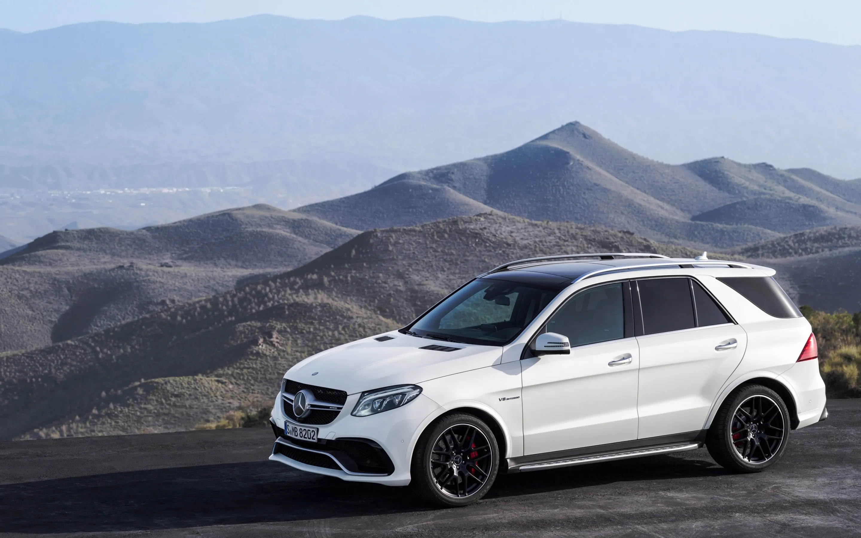 White Mercedes SUV Exploring Rugged Mountain Terrain