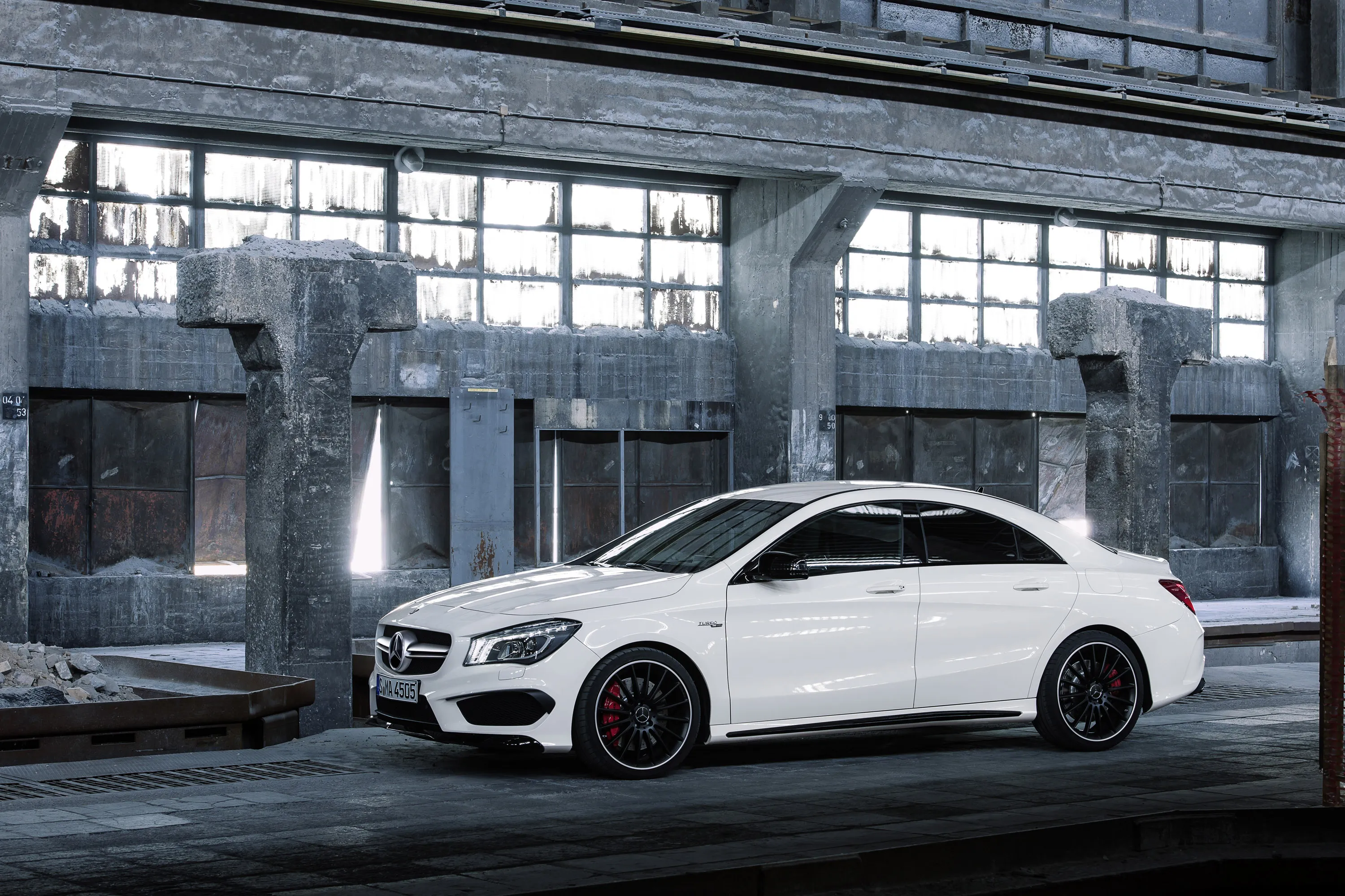 White Mercedes SUV Posed Inside Industrial Garage Space