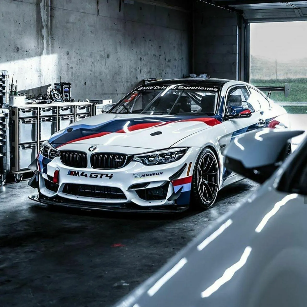 White Racing Bmw Car in Indoor Garage with Decals Wallpaper
