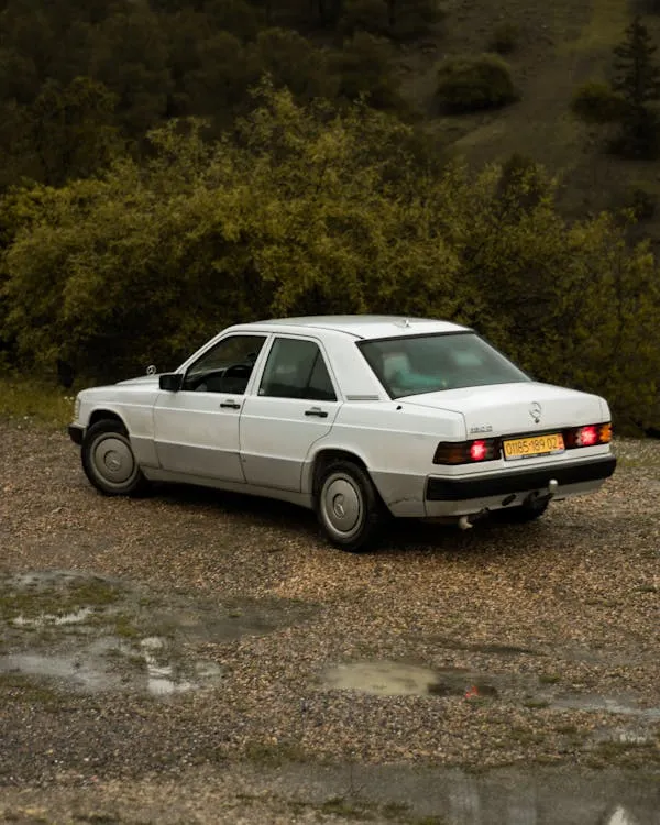 White Vintage Mercedes Benz Parked in Rural Setting image