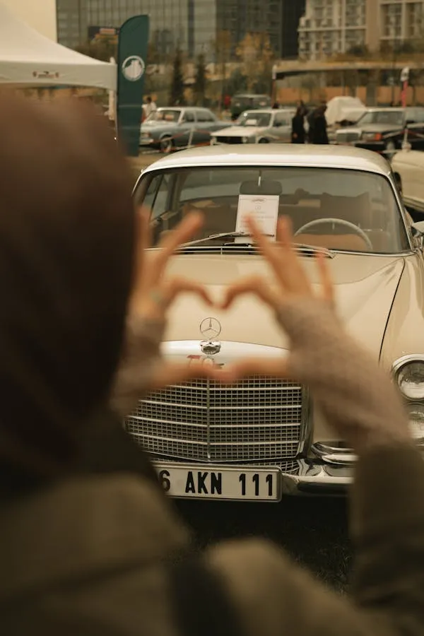 Woman Framing a Classic Benz in a Busy Street Wallpaper