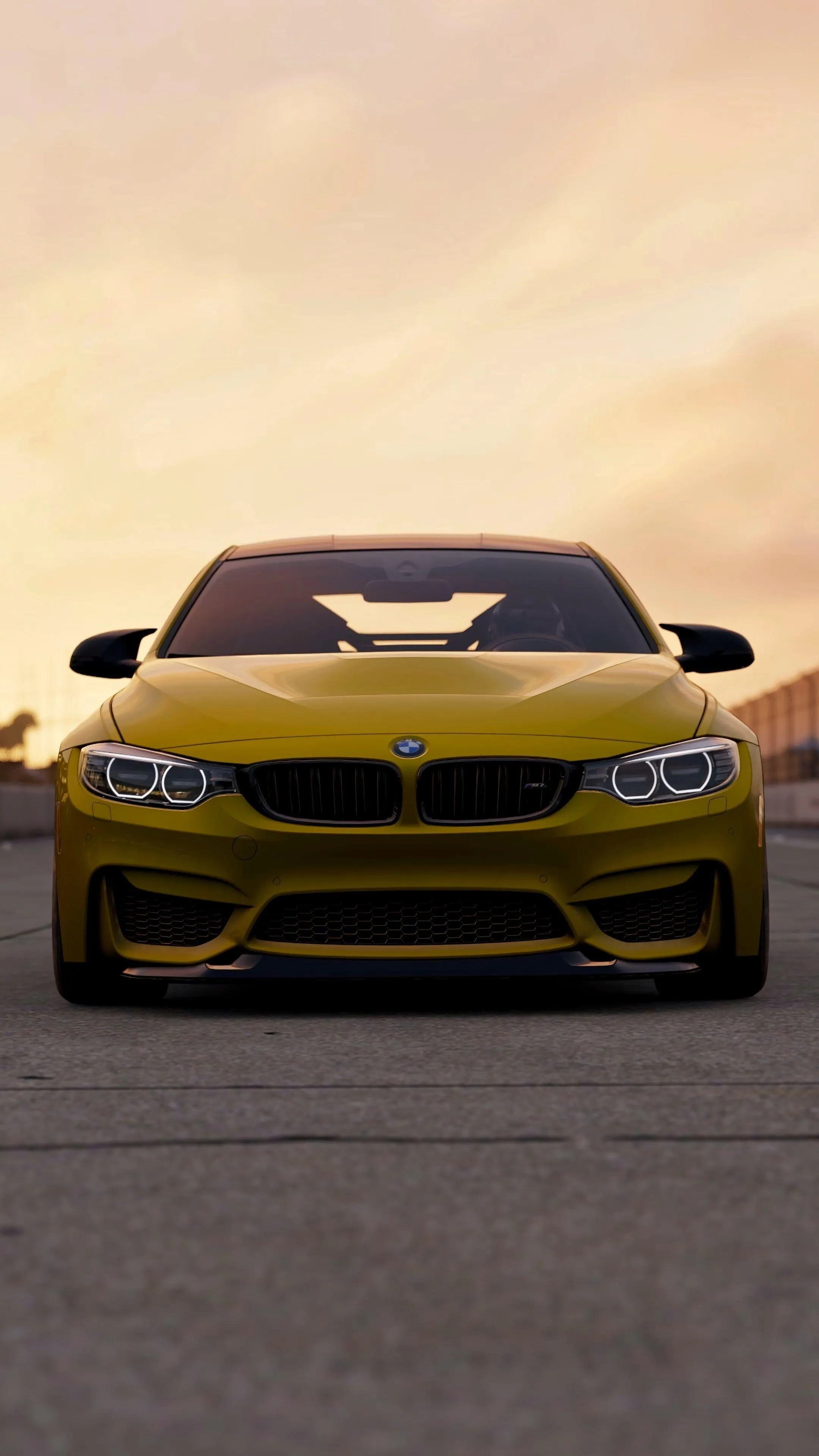 Yellow Bmw Coupe Parked Facing Forward During Sunset