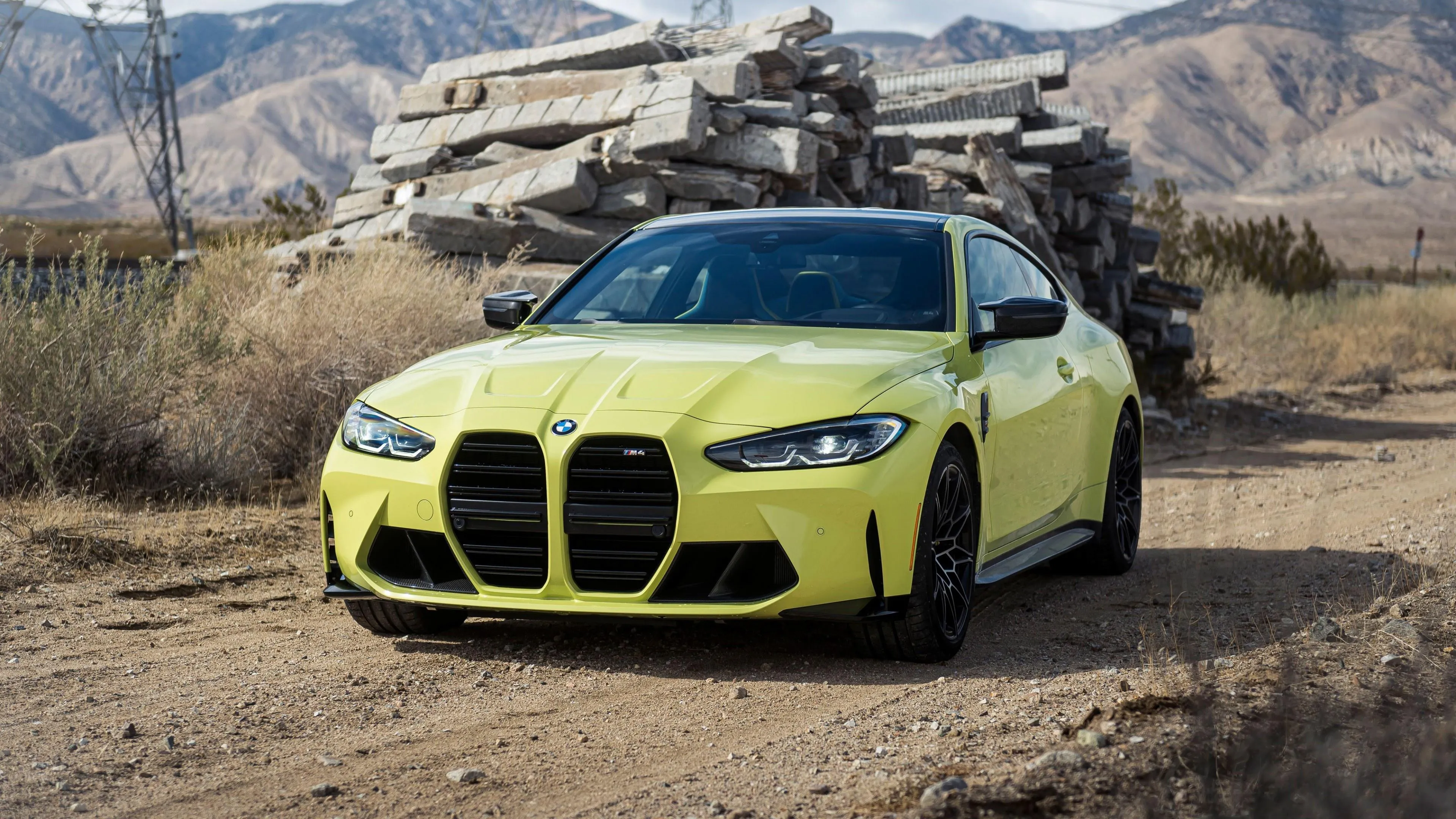 Yellow Bmw Driving in Rugged Desert Mountain Terrain