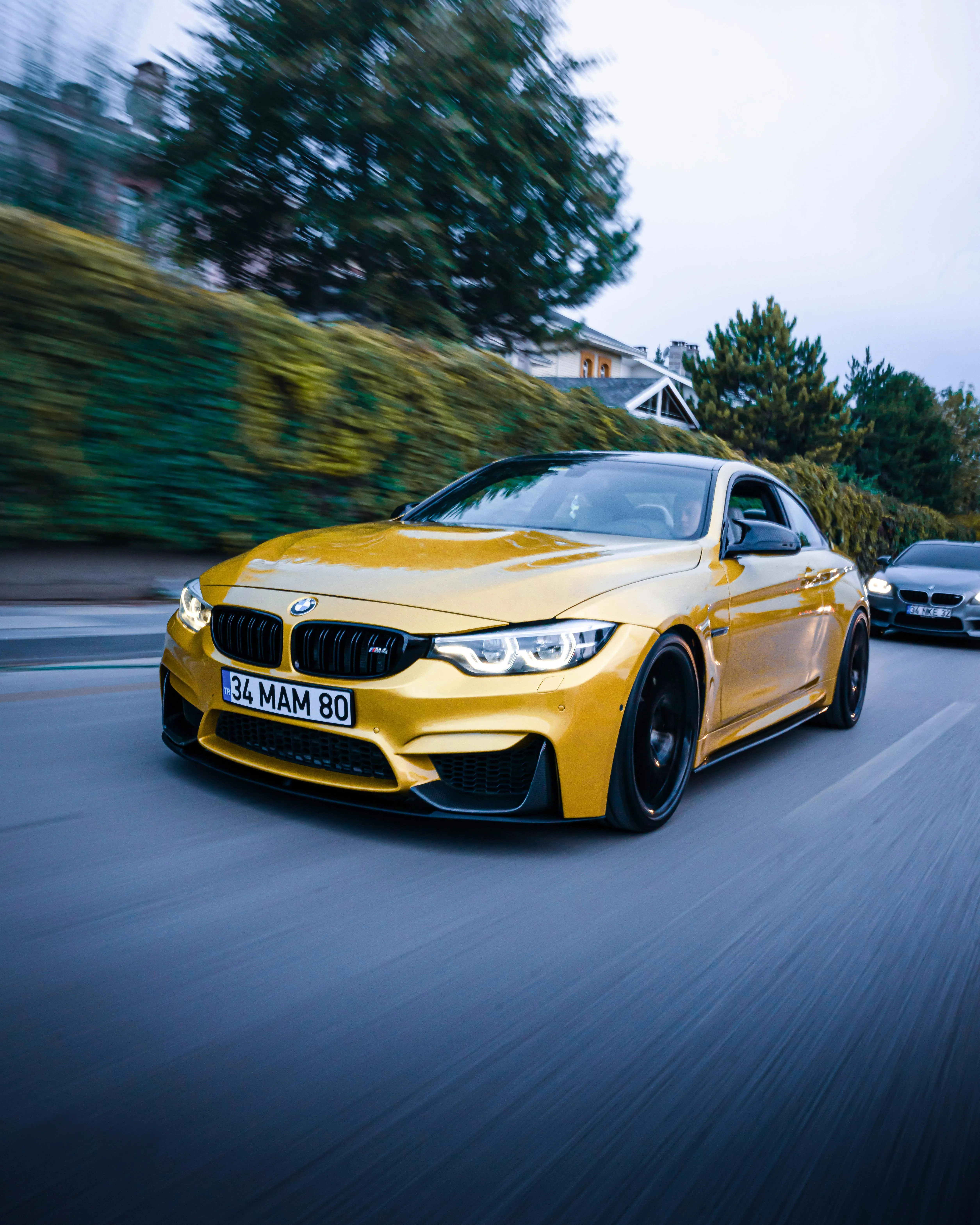 Yellow Bmw Racing Down a Road in Motion Blur Image