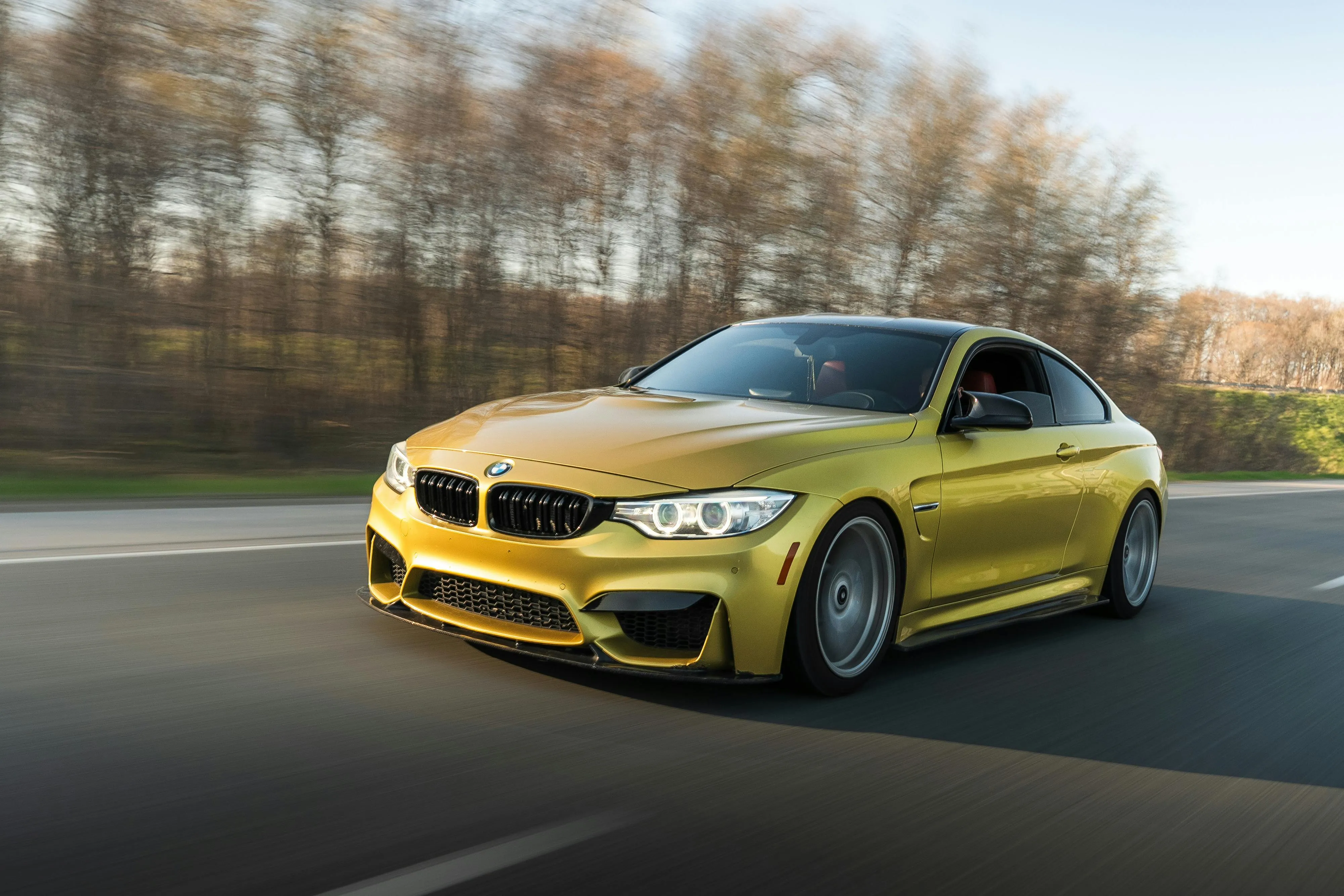 Yellow Bmw Speeding on Road with Blurred Background