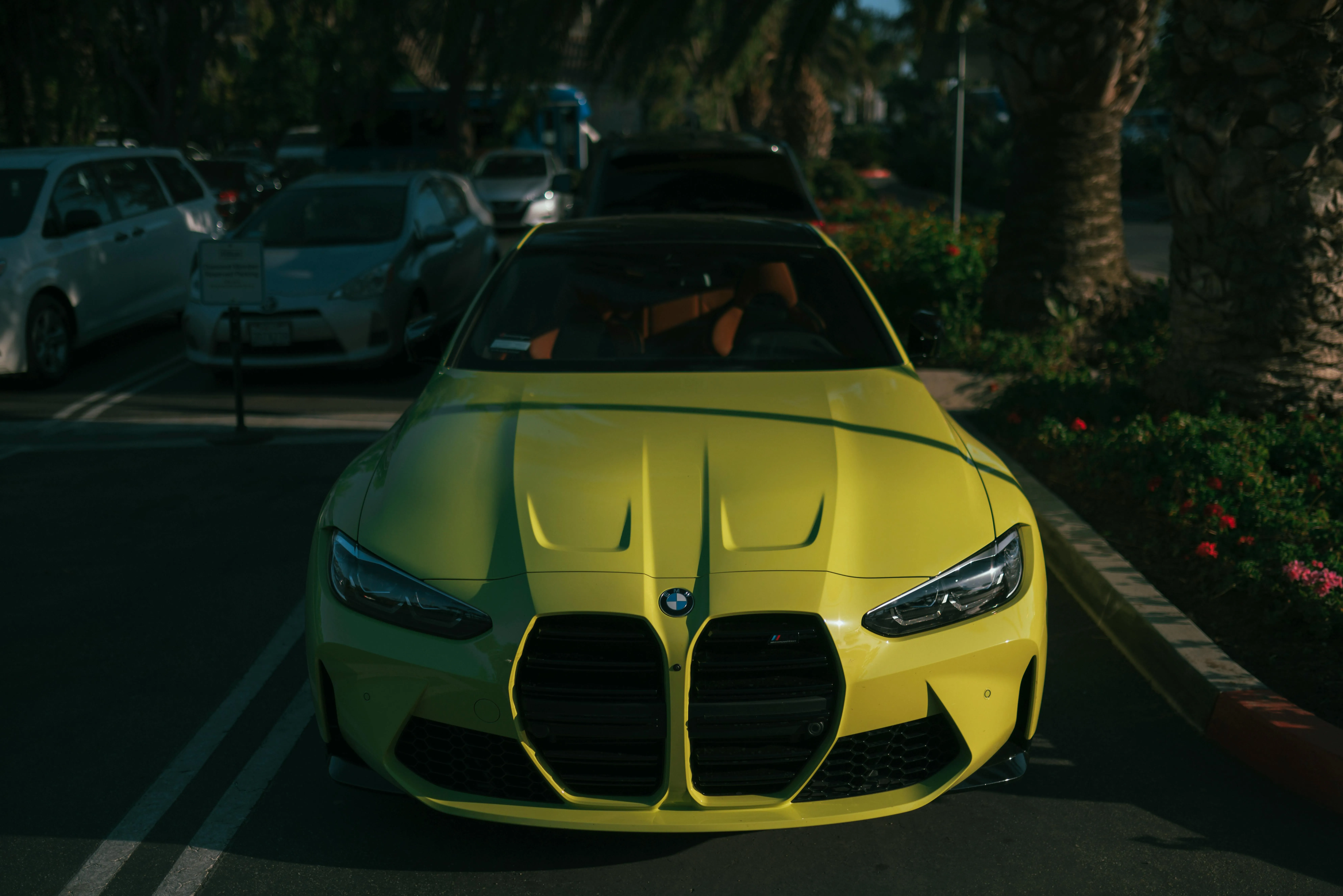 Yellow Bmw Sports Car Parked at Night Under Streetlights