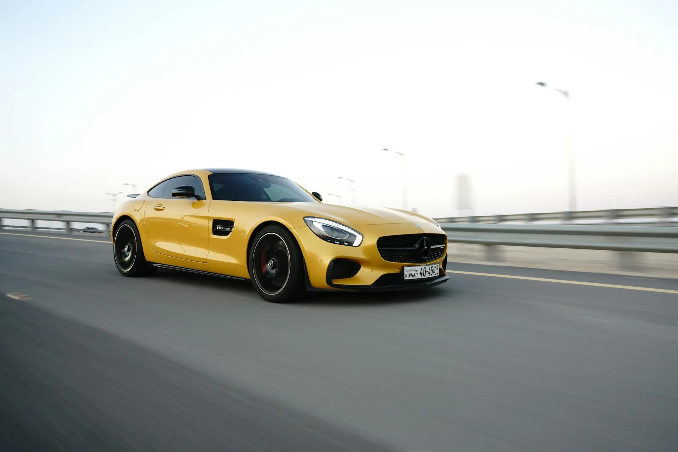 Yellow Mercedes AMG Driving on Highway Bridge HD Wallpaper