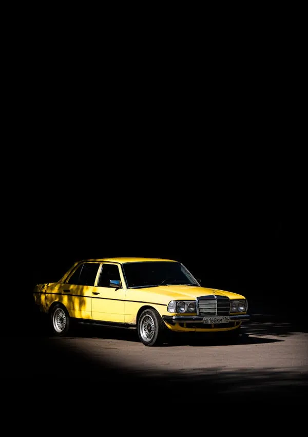 Yellow Mercedes Benz in Spotlight with Dark Background HD