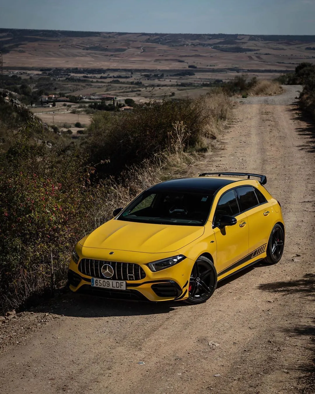 Yellow Mercedes Benz Sports Car Driving on Dirt Road