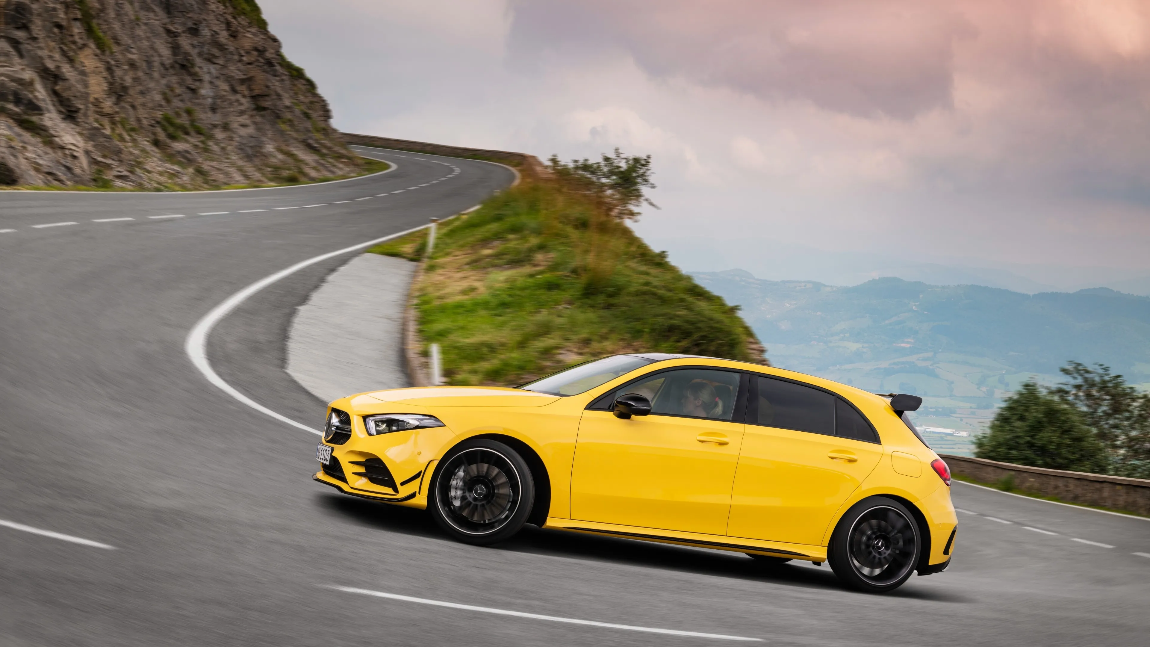Yellow Mercedes Benz Sports Car Driving on Winding Road