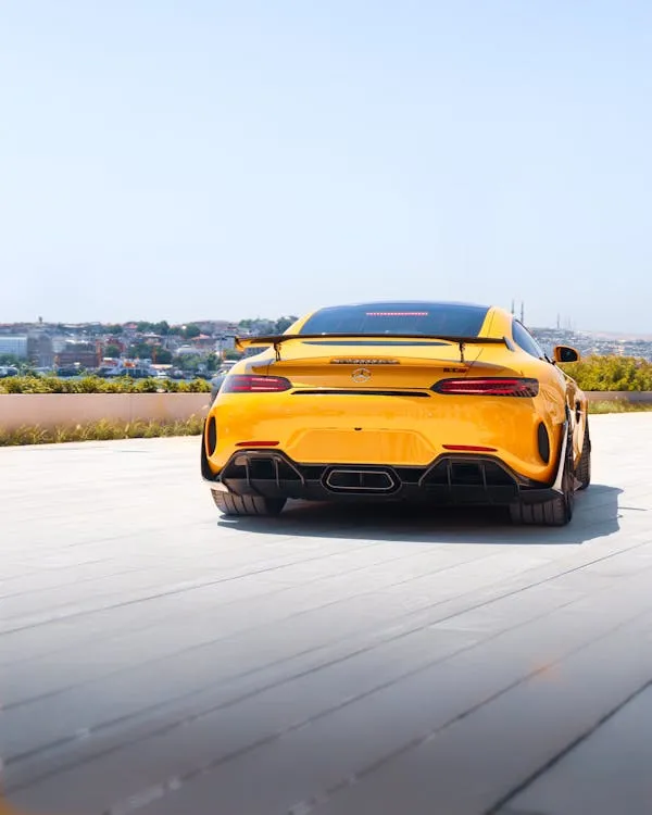 Yellow Mercedes Benz Sports Car Parked in Bright Outdoor Setting