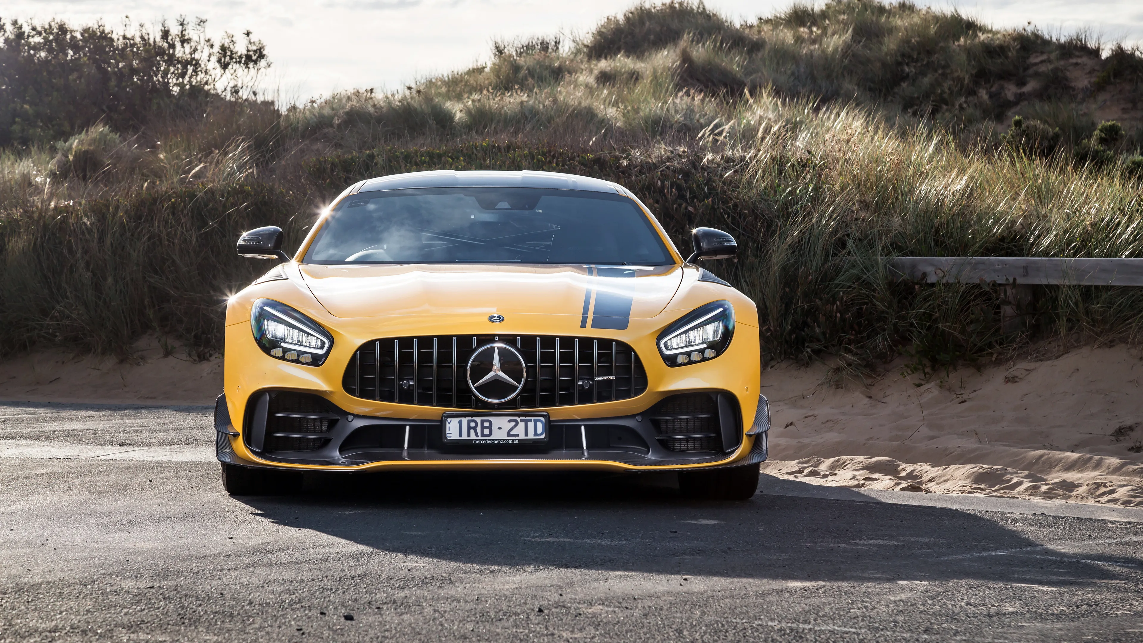 Yellow Mercedes Benz Sports Car Parked in Outdoor Setting