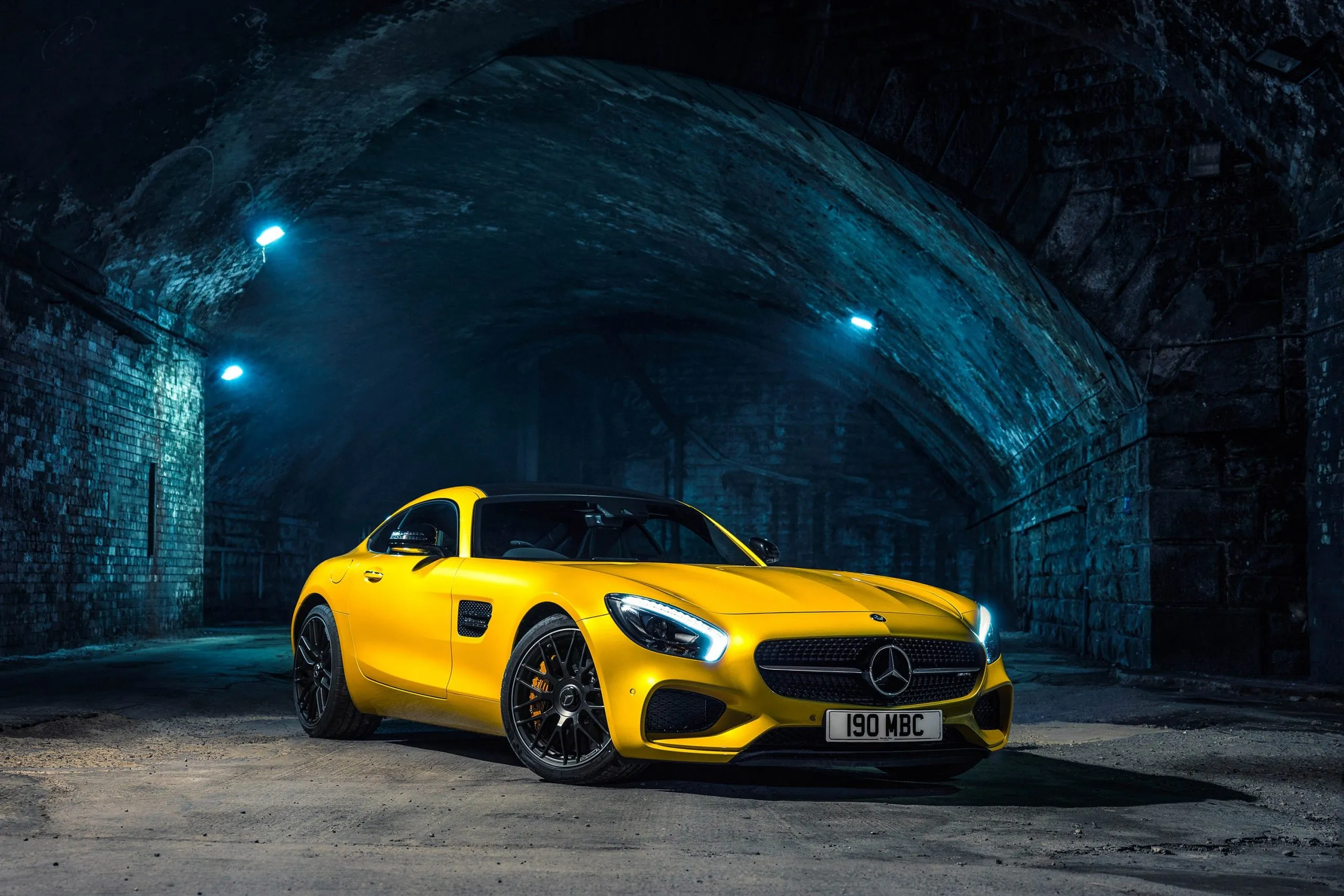 Yellow Mercedes Benz Sports Car Parked Inside Blue Lit Tunnel