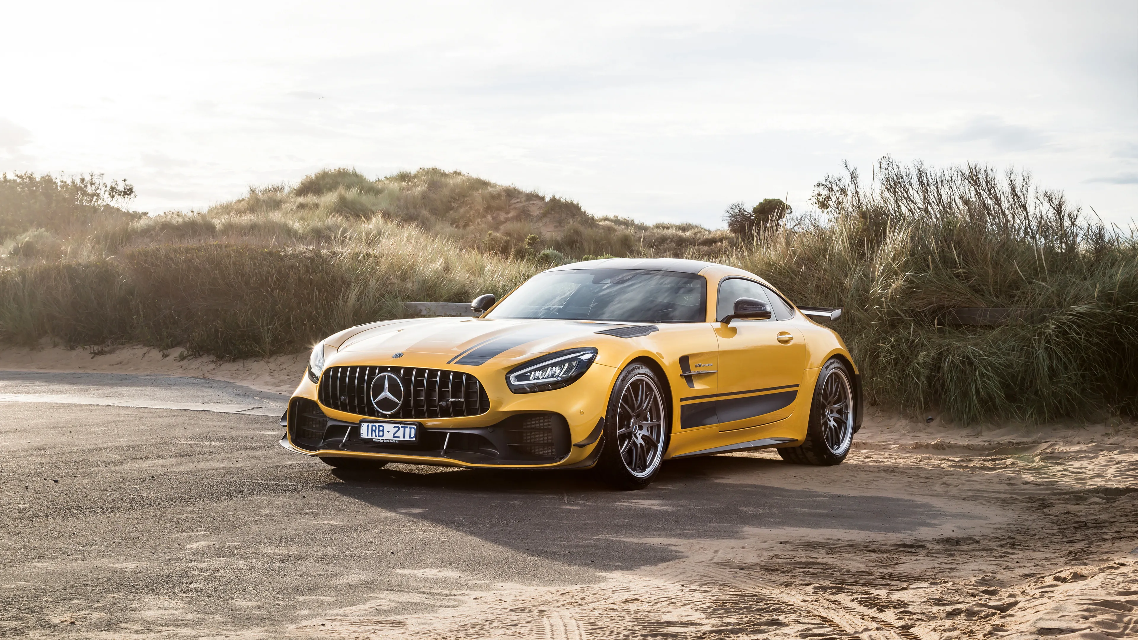 Yellow Mercedes Benz Sports Car Parked on Sandy Terrain
