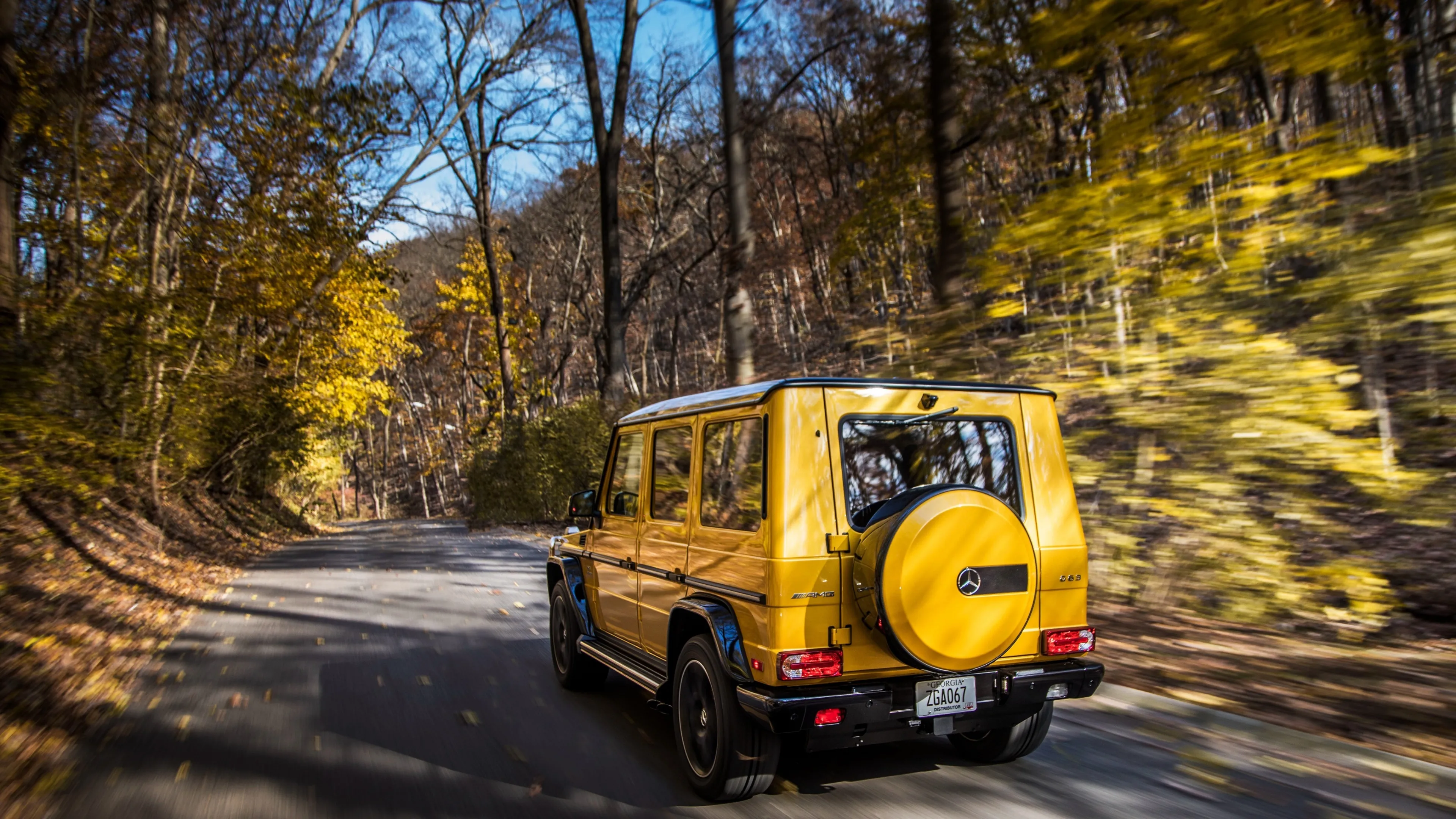 Yellow Mercedes Benz SUV Driving on Forest Road Wallpaper